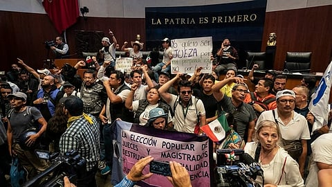 Protesters interrupt a Senate session in which lawmakers were debating the government's proposed judicial reform,